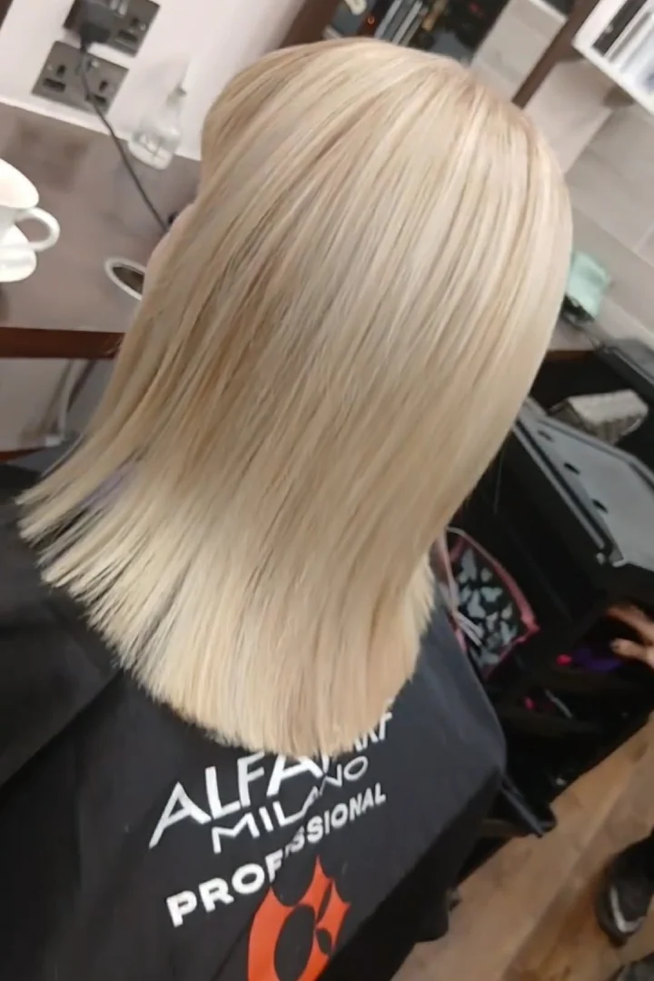 blond hair of a woman at a hair salon from the back
