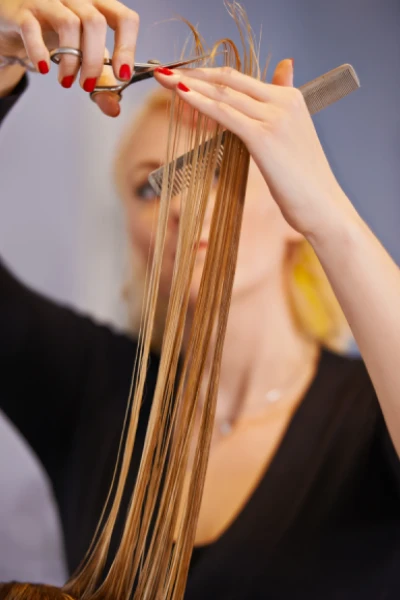 hairdresser cutting ends of a woman's hair