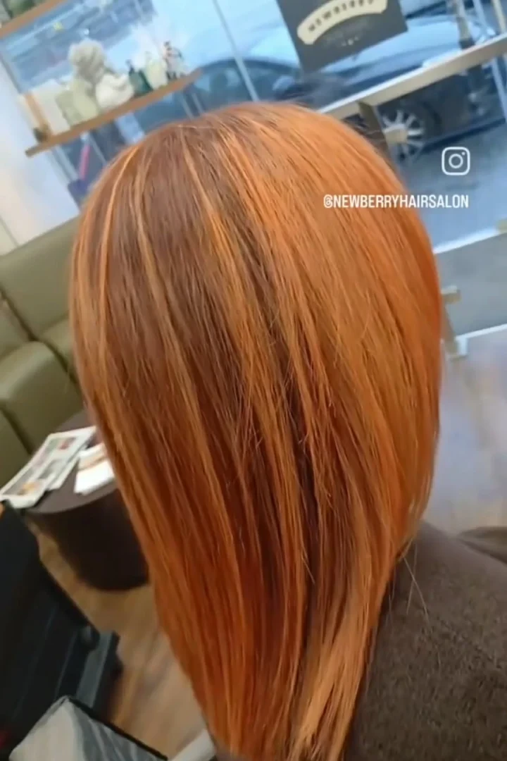 woman's orange hair at a salon